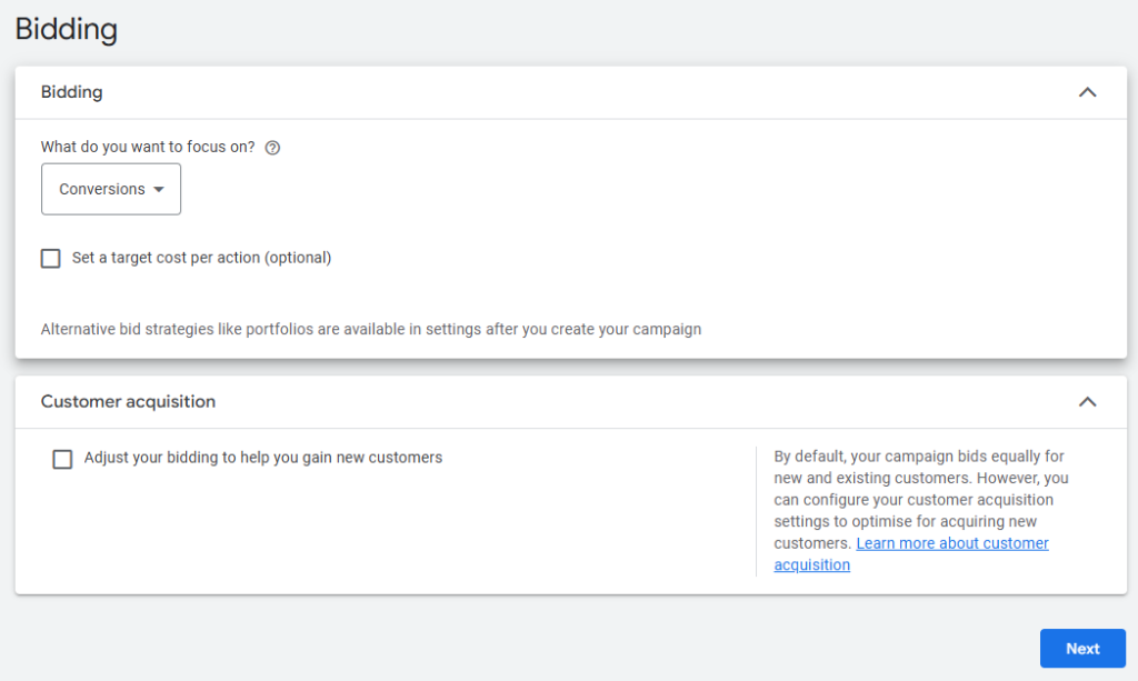 Google Ads bidding settings screen showing options to focus on conversions with an optional target cost per action. There is also a section for customer acquisition, where you can adjust bidding to help gain new customers. A note explains that by default, bids are equal for new and existing customers, but customer acquisition settings can be configured for optimisation. A 'Next' button is visible at the bottom right.