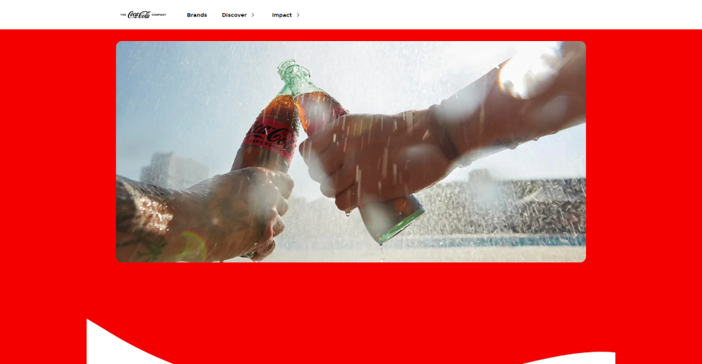 A screenshot of Coca-Cola's website featuring a bold and dynamic design. The page is dominated by Coca-Cola's signature red, with a large, vibrant image in the center showing two hands clinking classic glass Coca-Cola bottles amidst a refreshing splash of water. The top navigation is simple, with the Coca-Cola logo in black and white on the left and minimal text links for "Brands," "Discover," and "Impact" on the right. The use of red as the primary background color reinforces Coca-Cola's iconic brand identity, while the image captures the essence of refreshment and enjoyment associated with the brand. The overall design is striking and energetic, effectively using color and imagery to convey the brand's core values.